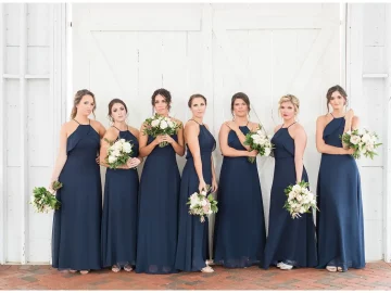 a group bridesmaids wearing navy blue bridesmaid dresses