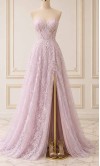 Model wearing a strapless lilac floral lace prom dress with a sheer corset bodice and high leg slit