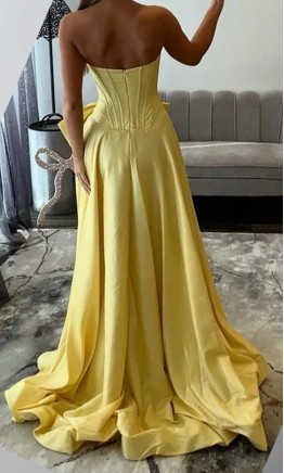 Pink embellished strapless corset prom dress with bows front view