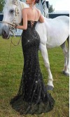 Glamorous black strapless prom dress with sheer corset bodice, sequin patterned lace, and high leg slit HPPD718