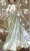 Front swirling view of a metallic champagne gold one-shoulder A-line prom gown with micro-pleated skirt detail