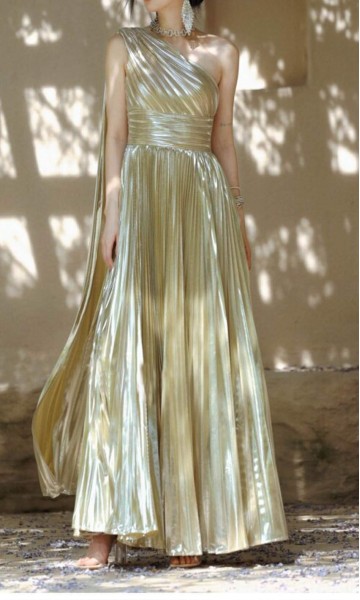 Front swirling view of a metallic champagne gold one-shoulder A-line prom gown with micro-pleated skirt detail